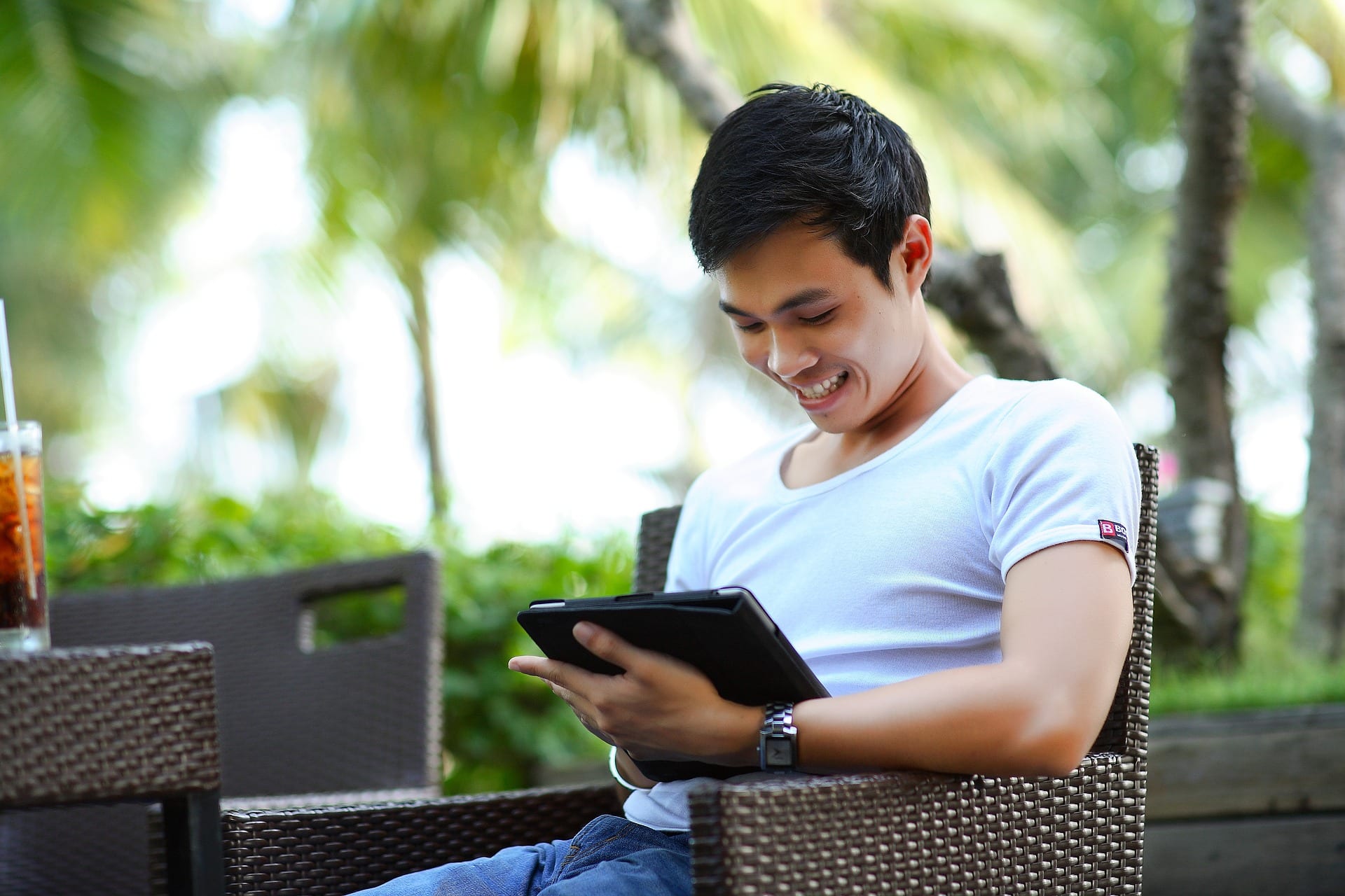 Jubilant young man using a tablet.