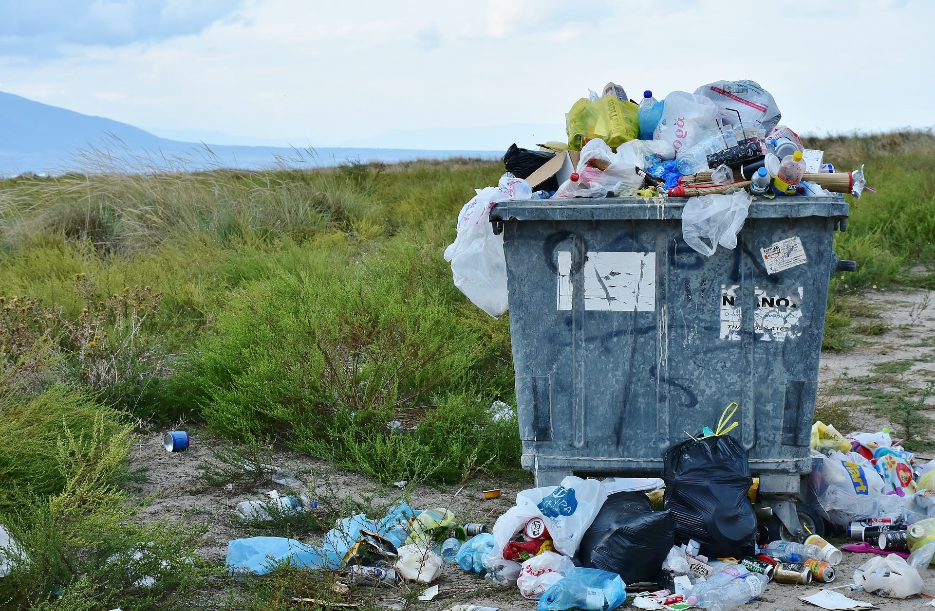 A dumpster overflowing with garbage.