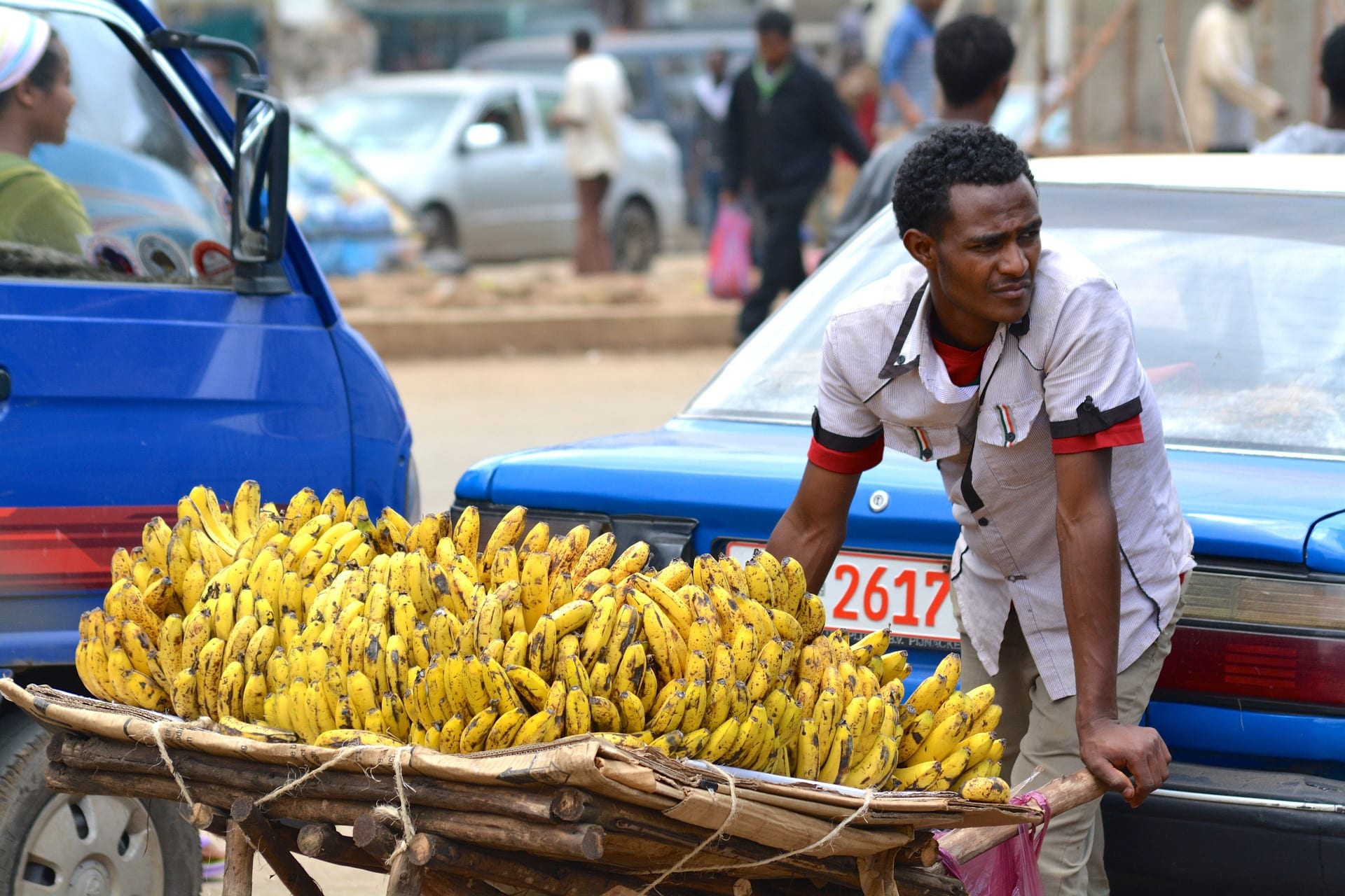 A vendor selling bananas from a cart.